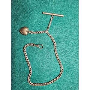Vintage curb link watch chain with a bar and heart charm.